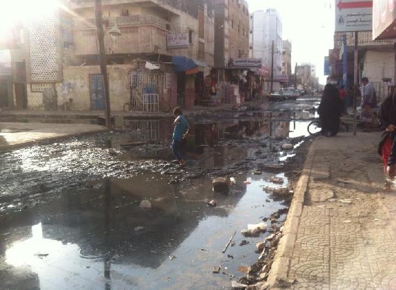 Women and children find difficulty walking on the street as they are filled by the overflow of cesspits.
